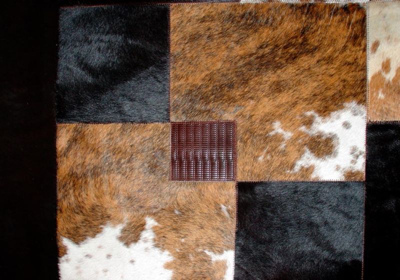 Detail of a checkered carpet with inserts in natural ponyskin, tricolour, dark brown, vegetal fir and woven print fir